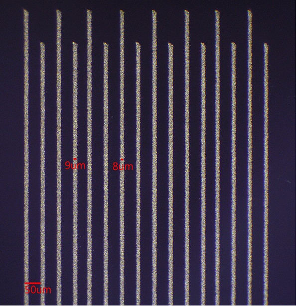 Micrograph of sub 10-micron wide IDS NanoJet printed gold traces on glass
