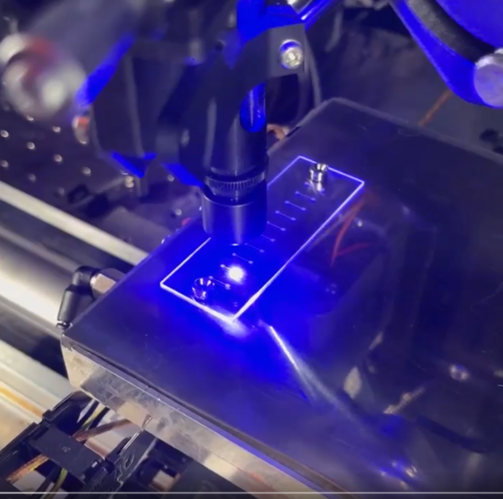 Video still of a close up video showing laser sintering of NanoJet aerosol printed traces